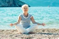 Senior woman doing yoga exercises