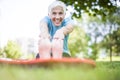 Senior woman doing yoga and legs stretching  in the park Royalty Free Stock Photo