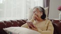 Senior woman doze asleep while listening music with smartphone