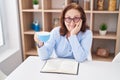 Senior woman drinking coffee reading book at home Royalty Free Stock Photo