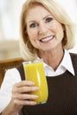 Senior Woman Drinking A Glass Of Orange Juice Royalty Free Stock Photo