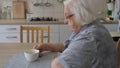 Senior woman is drinking her morning coffee in the kitchen Royalty Free Stock Photo