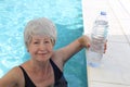 Senior woman drinking water in the summer heat Royalty Free Stock Photo