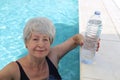Senior woman drinking water in the summer heat Royalty Free Stock Photo