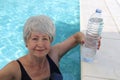 Senior woman drinking water in the summer heat Royalty Free Stock Photo