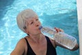 Senior woman drinking water in the summer heat Royalty Free Stock Photo