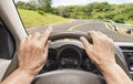 Senior woman driving a car on highway