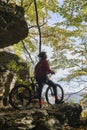 Senior woman on e mountain bike in autumn forest