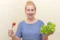 Senior woman eating fresh green salad and tomato Royalty Free Stock Photo