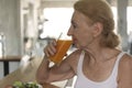 Senior woman eating healthy salad and orange juice. elderly health lifestyle concept Royalty Free Stock Photo