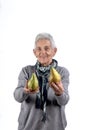 Senior woman eating pear on white Royalty Free Stock Photo