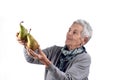 Senior woman eating pear on white Royalty Free Stock Photo