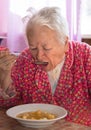 Senior woman eating soup