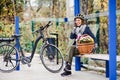 A senior woman with electrobike and flowers sitting on a bench outdoors in town. Royalty Free Stock Photo