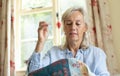 Senior Woman Embroidering Cushion Cover At Home Royalty Free Stock Photo