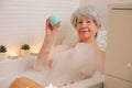 Senior woman enjoying a blue bath bomb