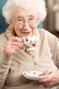 Senior Woman Enjoying Cup Of Tea At Home Royalty Free Stock Photo