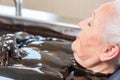 Senior woman enjoying mud bath alternative therapy Royalty Free Stock Photo