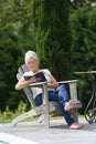 Senior woman enjoying reading outdoors Royalty Free Stock Photo