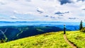 Senior Woman enjoying the view on a hike on Tod Mountain near the alpine village of Sun Peaks in the Shuswap Highlands, BC Royalty Free Stock Photo