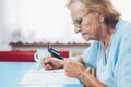 Senior woman enjoys solving a crossword puzzle Royalty Free Stock Photo