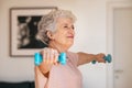 Senior woman exercising with dumbbells at home Royalty Free Stock Photo