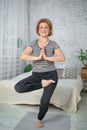 Senior woman exercising home, the concept of a healthy lifestyle, fitness and yoga Royalty Free Stock Photo