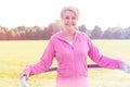 Active Senior woman exercising with hula hoop in park Royalty Free Stock Photo