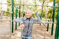Senior Woman Exercising At Outdoor Fitness Park