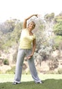 Senior Woman Exercising In Park Royalty Free Stock Photo