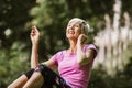 Woman exercising in park while listening to music Royalty Free Stock Photo
