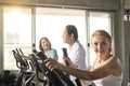 Senior woman exercising spinning bike in fitness gym. elderly healthy lifestyle concept Royalty Free Stock Photo