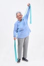 Senior woman exercising on white background