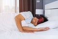 Senior woman with eye mask sleeping on a bed Royalty Free Stock Photo