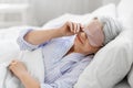 senior woman with eye sleeping mask in bed at home Royalty Free Stock Photo