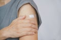 Senior woman feel painful her arm after got vaccinated or inoculation due to spread of corona virus Royalty Free Stock Photo