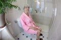 Senior woman feeling constipated in the bathroom Royalty Free Stock Photo