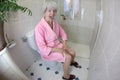 Senior woman feeling constipated in the bathroom