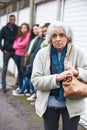 Senior Woman Feeling Intimidated By Group Of Young People