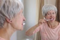 Senior woman feeling pain while brushing her teeth Royalty Free Stock Photo