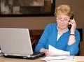 Senior woman filing taxes on line