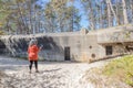 Senior woman filming the ruins of the abandoned WWII bunker