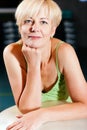 Senior Woman with fitness ball in gym