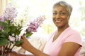 Senior Woman Flower Arranging At Home