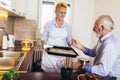 Senior woman with fresh baked cookies with his husband Royalty Free Stock Photo