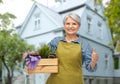 senior woman with garden tools showing thumbs up