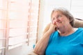 Senior Woman Gazing Out of Her Window