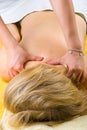 Senior woman getting a deep shoulders massage Royalty Free Stock Photo