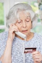 Senior Woman Giving Credit Card Details On The Phone Royalty Free Stock Photo