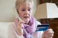 Senior Woman Giving Credit Card Details On The Phone Royalty Free Stock Photo